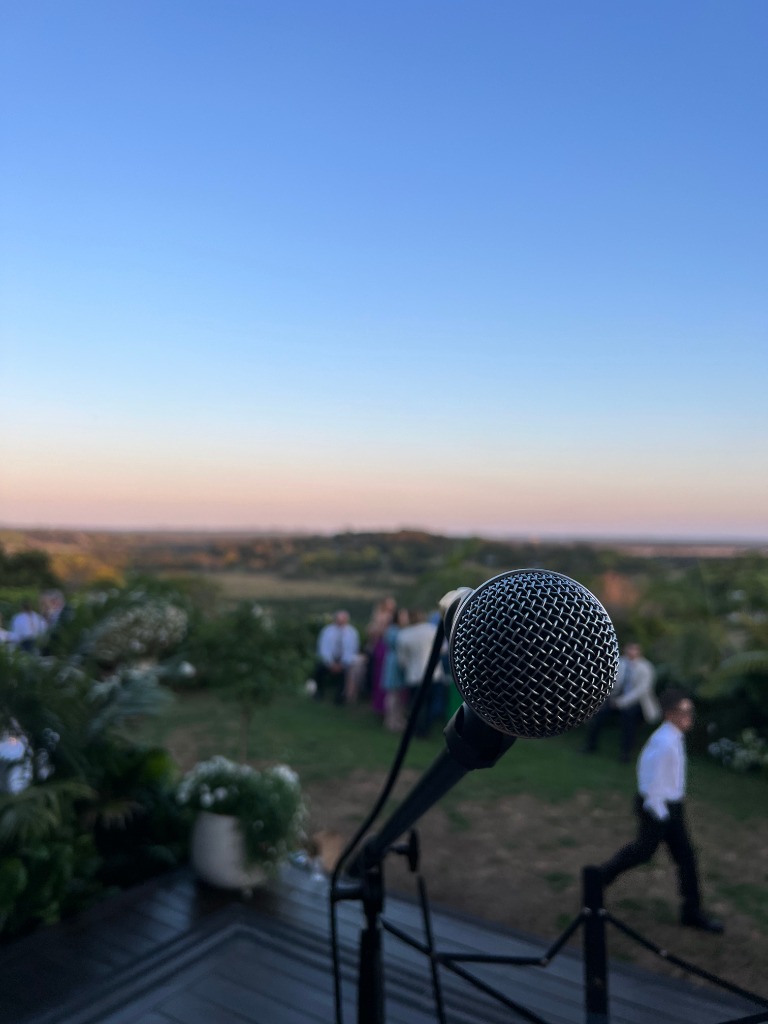 Cordless wireless microphone sound setup overlooking sunset Byron Bay hinterland wedding