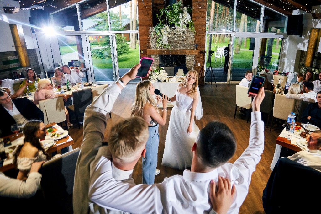 Live wedding vocal performance and guests celebrating at reception