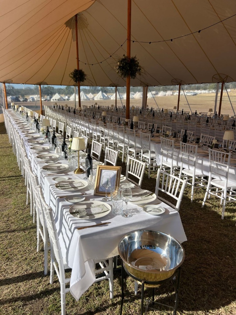 Banquet tables set inside marquee at Kemmis Station
